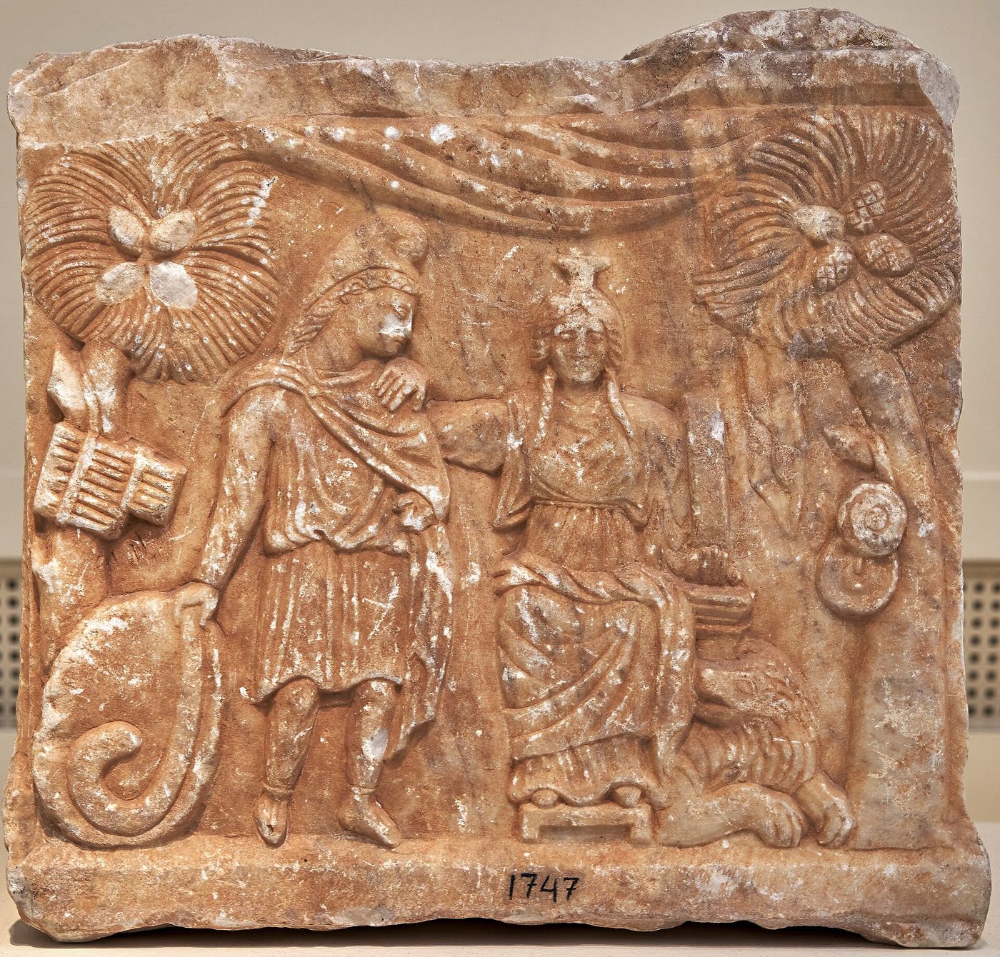 A carved marble altar from the fourth century CE showing Cybele enthroned with her hand on the shoulder of Attis, flanked by pine trees.