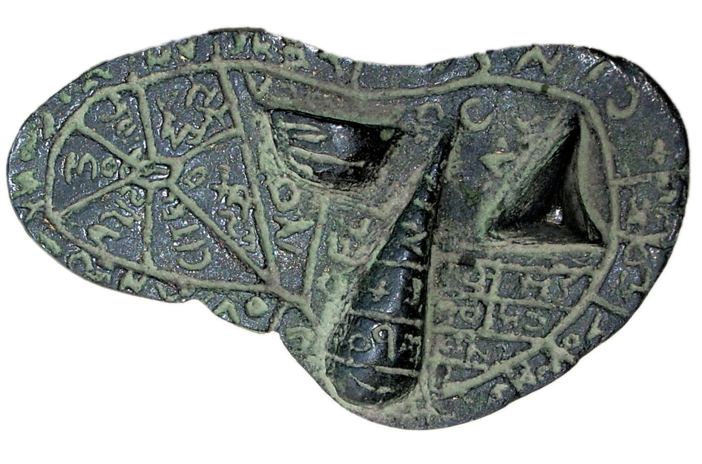 A bronze model of a sheep's liver, its flat surface divided into many small compartments each carrying an inscription.