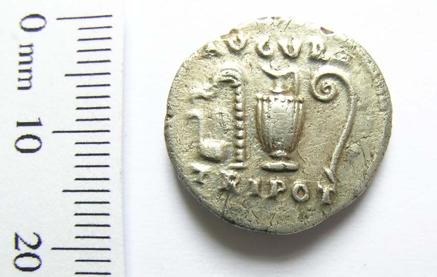 The reverse of a Roman silver denarius of Vespasian, showing a set of priestly religious implements including an augur's curved lituus staff.